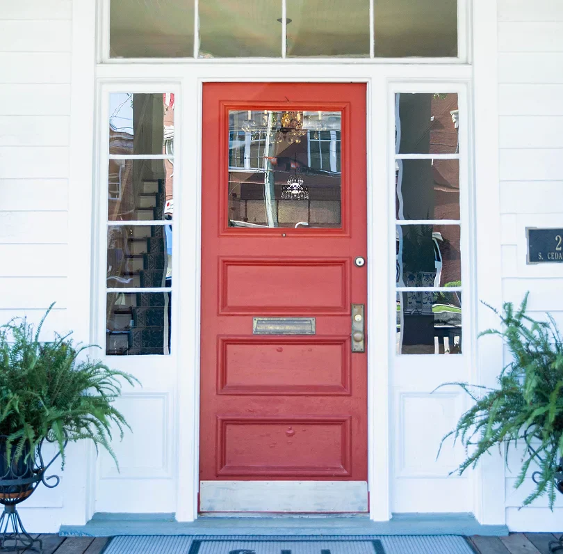 Front entrance of Gil Gatch Law office with a red door and white exterior